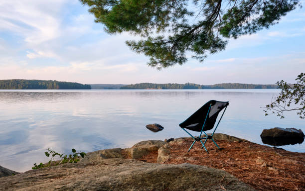 istock Camping chair overlooking lake 1645262075