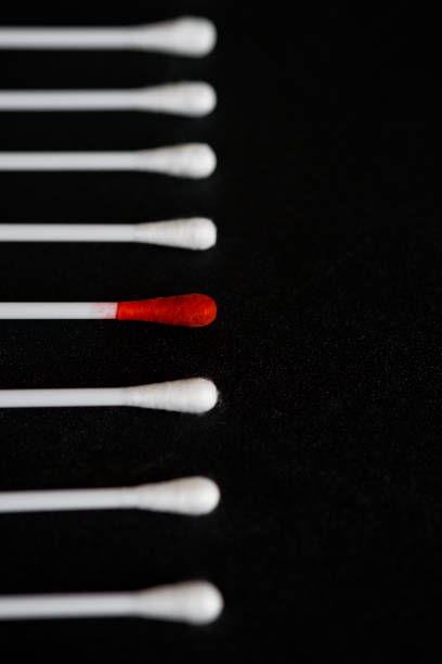 Close-up view of red cotton buds among whites stock photo