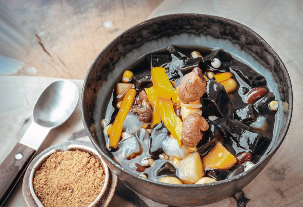 istock Black Grass Jelly is including Nuts, Cereals, Red beans, Ginkgo, Sliced pumpkin, Corn kernels, Millet, Sweet potato, Palm seed and Jelly in Longan Juice which is served with Brown sugar. 1645269695