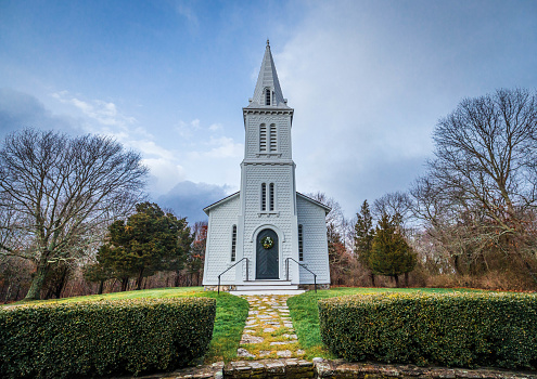 The white steeple reaches up as a sign of worship. This is one of the many stunning churches that has survived time and weather creating a haven of rest for many.