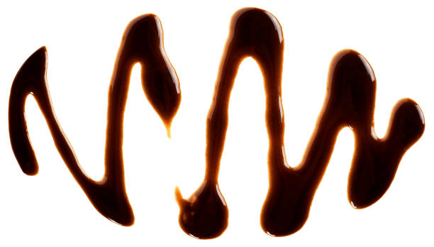 istock Sweet chocolate sauce isolated on a white background, top view. Chocolate syrup. Chocolate topping. 1645337034