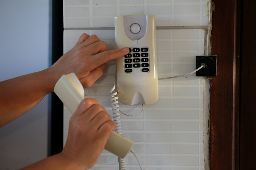 salvador, bahia, brazil - august 26, 2023: person using communication terphone in a residence in the city of Salvador.
