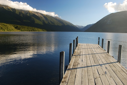 Evening Light on Lake Rotoiti. Looking up the Jetty at the head of Lake Rotoiti through the St Arnaud Ranges & Mt Robert the into the valleys beyond.