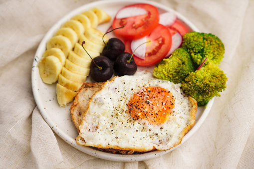 breakfast fried egg toast with vegetables and fruits on white background