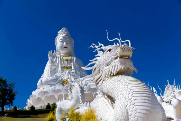 Big statue white Guanyin and  blue sky at Wat Huay Pla Kang Chiang Rai, thailand