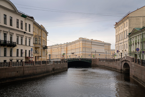 St. Petersburg, Russia, 04.30.2023: Moika River embankment and view of the east wing of the General Staff Building on a summer day with clouds