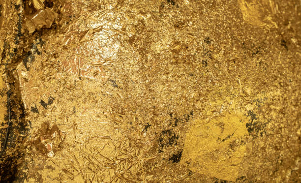 istock Golden painted concrete wall background. Shiny gold foil abstract texture 1645450548