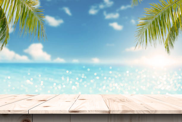 istock Empty wooden table are placed outdoors on spring sunny sky background with blue sparkling sea water and bokeh blurry. Counter display concept 1645456372