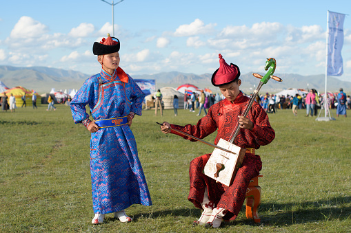 Ulaanbaatar, Tuv, Mongolia - August 12, 2023: Boy is singing a Mongolian long song. Nomads world cultural festival Mongolia