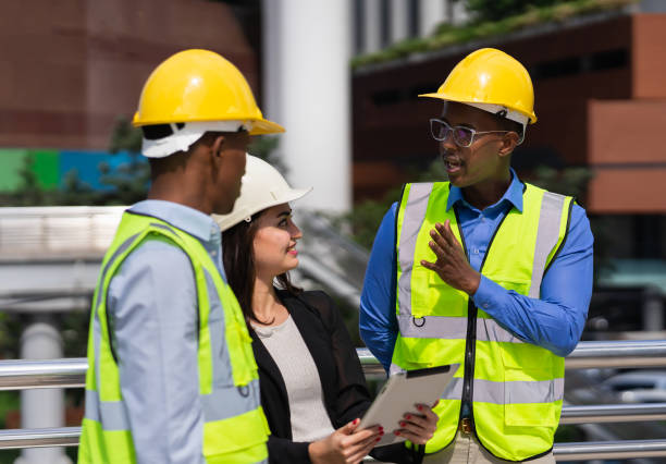 istock black executive engineer working at construction site outside building in city and talking with caucasian businesswoman and black engineer 1645491240