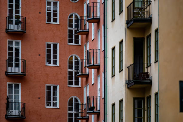Stockholm, SwedenA classic residential building courtyard with windows and balconies in orange and yellow.