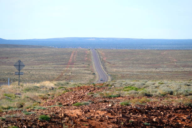 View of the Stuart Highway through the arid lands in South Australia. It is a major Australian highway that runs from Darwin, in the Northern Territory, to Port Augusta in South Australia; a distance of 2,720 km (1,690 mi).