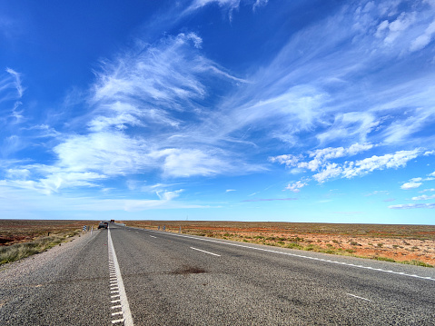 View of the Stuart Highway through the arid lands in South Australia. It is a major Australian highway that runs from Darwin, in the Northern Territory, to Port Augusta in South Australia; a distance of 2,720 km (1,690 mi).