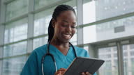 istock Black woman, nurse and tablet, hospital schedule and smile, typing and set medical appointment on online system. Healthcare employee, medicine and African, digital tech and research with health info 1645543756
