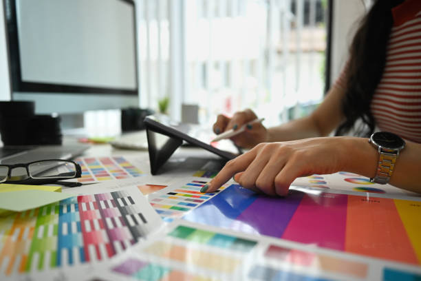 istock Closeup view female designer working with color palette, choosing color samples for design project at modern office 1645567699
