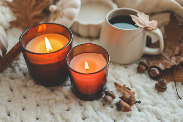 istock Two burning candles in the autumn interior 1645600407