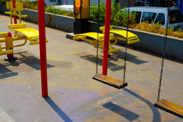 Textured Background Photography. Photo Background: Rows of swings in a city park. Red and yellow swing, no people, amusement park. Bandung - Indonesia