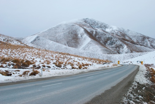 The scenic drive through the dramatic Lindis Pass links the Mackenzie Basin with Central Otago in the South Island of New Zealand. Alongside the highway is the Lindis Conservation Area where Mountains and snow tussock grassland dominates the landscape. 