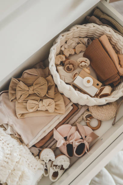 istock Dresser with clothes for a newborn, organizing storage 1645602011