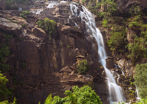Silky milky smooth Sita waterfall flowing over green rocky hills at Ranchi Jharkhand India