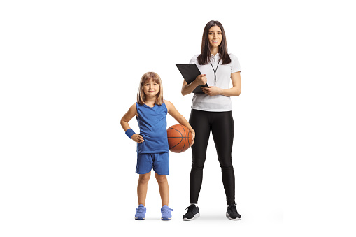 Female basketball coach standing with a girl in a sports jersey isolated on white background