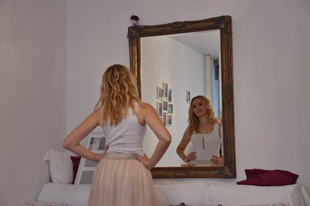 istock Mature woman looking in the mirror 1645712283