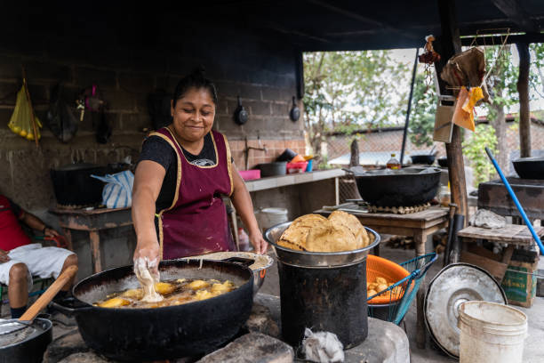 istock Latin woman working in a poor kitchen of a restaurant 1645720963