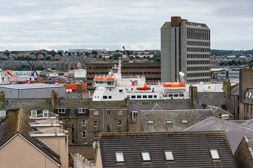 Ships tucked between buildings in the harbor of the Scottish city of Aberdeen, UK