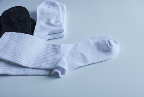 A pair of white socks on a white background. Casual wear.