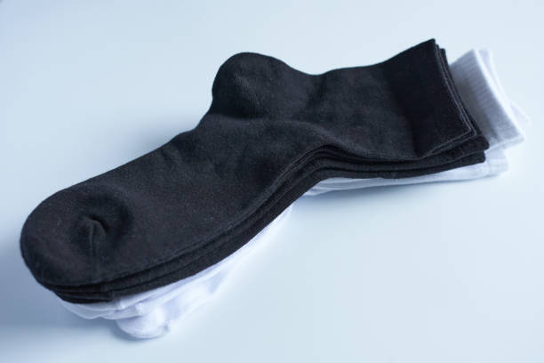 istock Black and white socks on a white background, close-up, top view. 1645728392