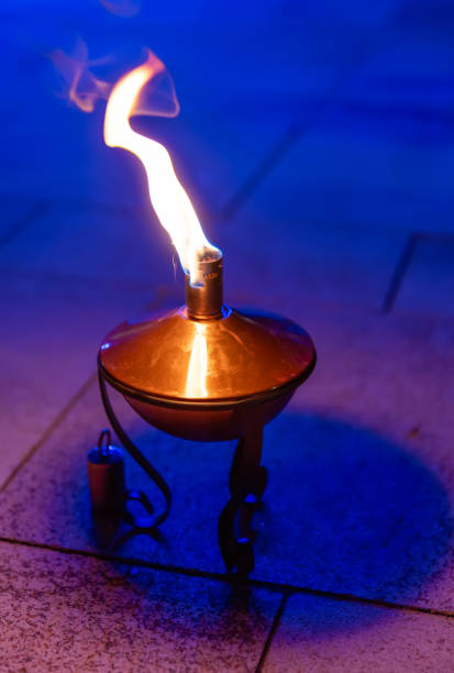 Burning oil lamp on floor at evening Burning oil lamp on floor at evening old oil lamp stock pictures, royalty-free photos & images