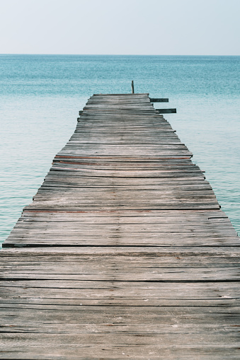 A long dock leading into the ocean