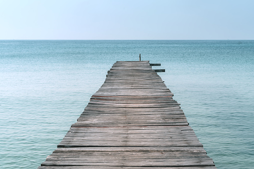 A long dock leading into the ocean