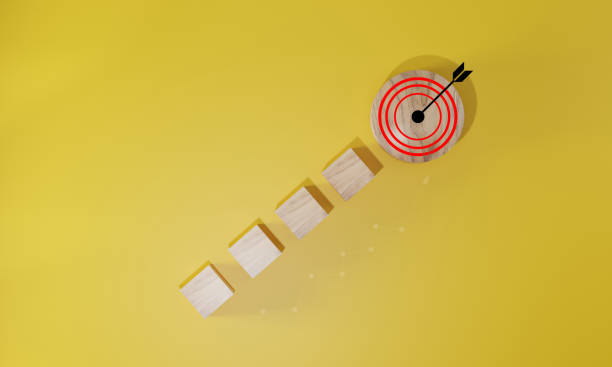 istock Virtual target board and arrow which print screen to wooden cube block on yelloow background. Business achievement goal and objective target concept. 1645789203