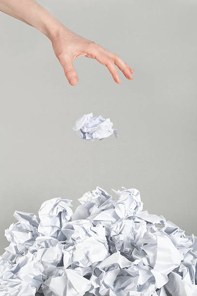 istock Stack of crumpled paper balls and hand on gray 164579796