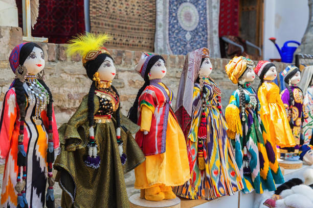 istock Dolls dressed in traditional uzbek costumes. Traditional souvenir puppet from painted mashed paper (papier mache). Close up, selected focus. Bukhara (Buxoro), Uzbekistan. Souvenir and gift concept 1645802399