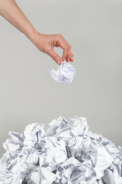 istock Stack of crumpled paper balls and hand 164581064