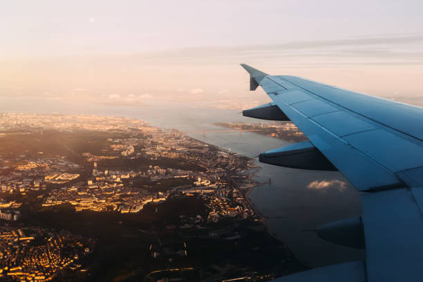 istock Airplane flying above beautiful bay and bridge upon it in evenin 1645812267