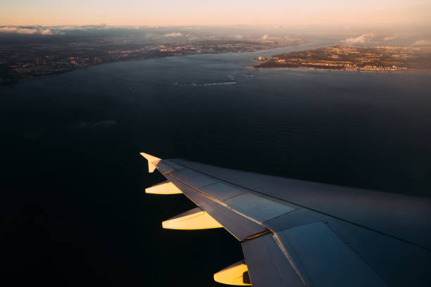 istock Plane wing above water in sunlight before landing 1645812278