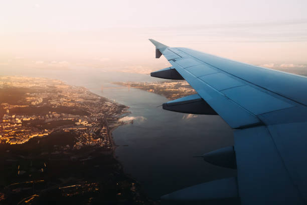 istock Airplane wing view from window seat above Vasco de Gama bridge i 1645812282
