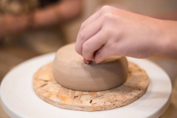 istock girl hands, pottery studio and painting cup in workshop for sculpture 1645828248