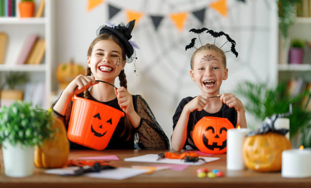 istock Happy family preparing for Halloween. 1645835676