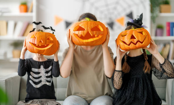istock Happy family preparing for Halloween. 1645836215