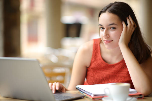 istock Confident student looking at you in a bar 1645840253