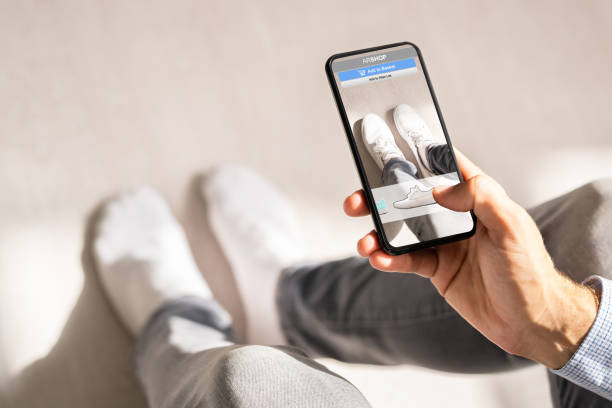 istock Man Trying Virtual Sneakers In Online Shop 1645852530