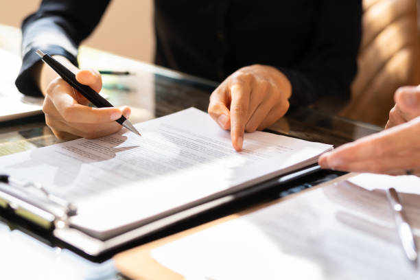 istock Two Businesspeople Working On Contract Paper 1645852531