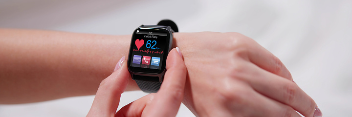 Smart Watch Showing Heartbeat Monitor On Woman's Hand