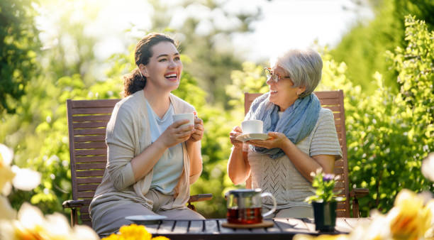 istock women drinking tea in the garden 1645860579