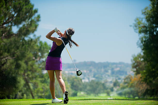 Golf Swing A golfer at the end of his golf swing. game swing stock pictures, royalty-free photos & images
