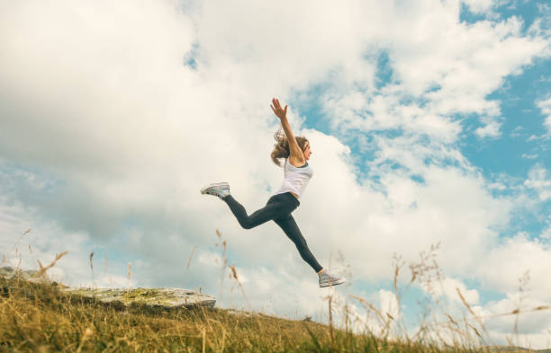 istock The woman jumps through the clouds. 1645861259